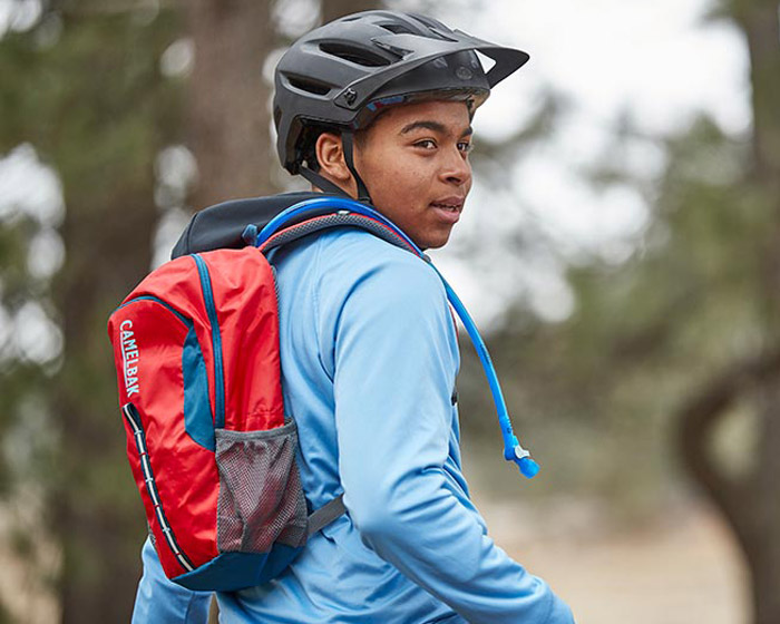Youth biking with helmet