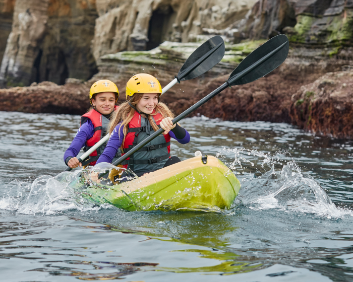 Children canoeing on a river