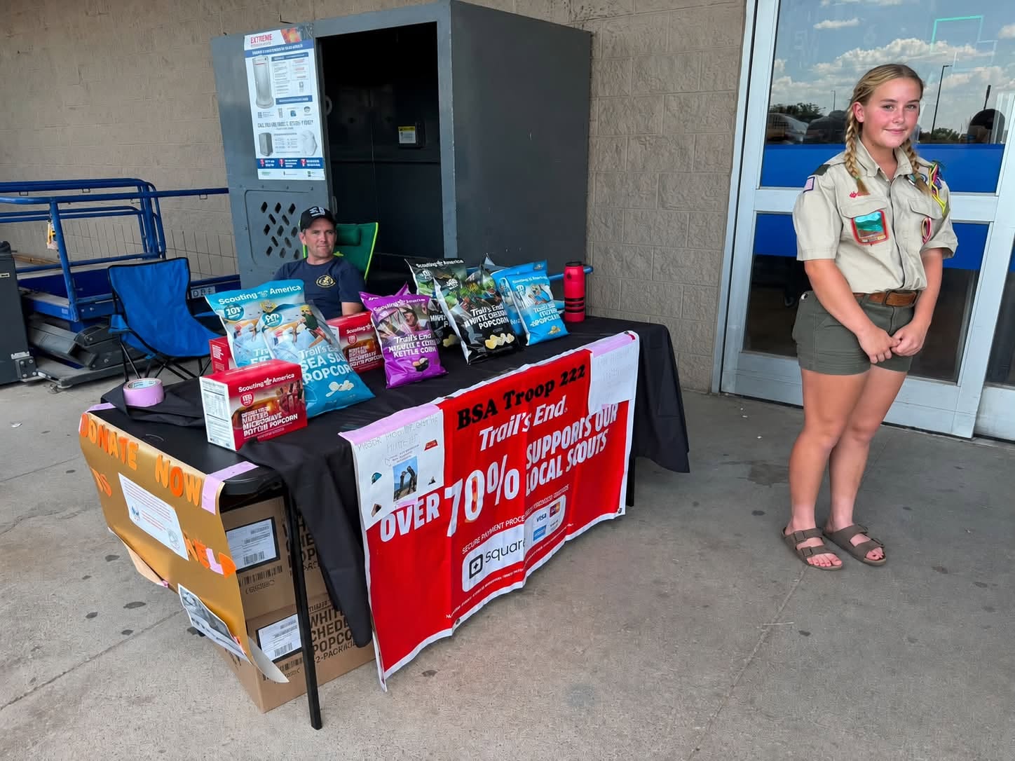 Scout selling popcorn during opening weekend